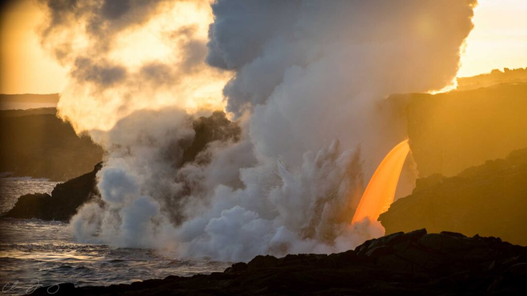 Lava entering the ocean at sunset.